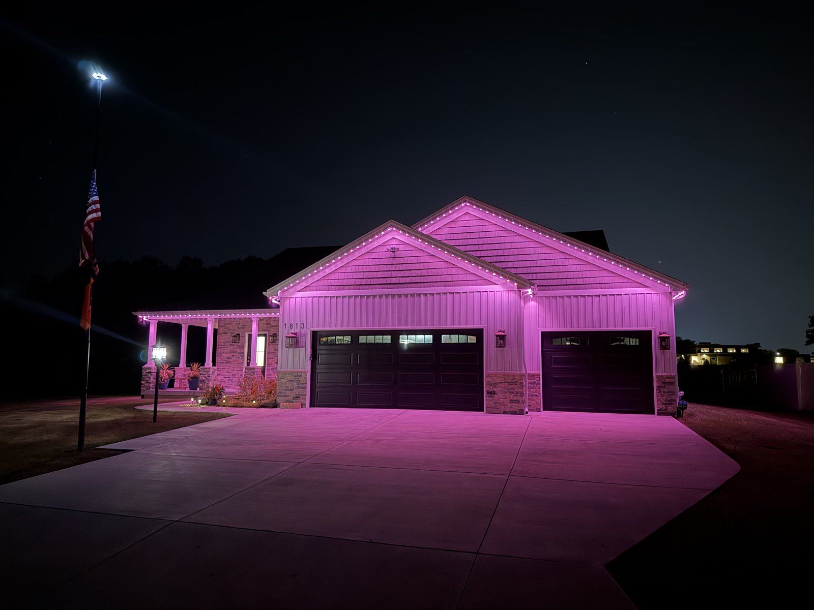 Orca permanent outdoor lighting on a home at night